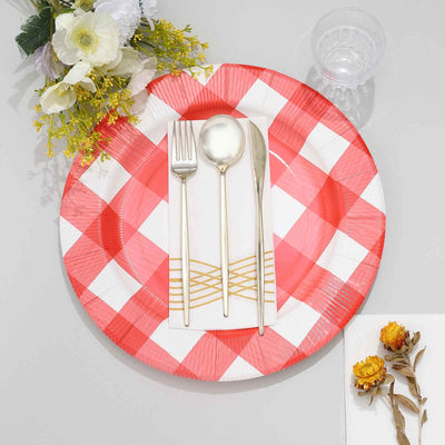 Red and white checkered plate set with silver utensils and decorative flowers.