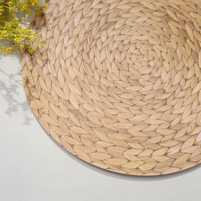 Woven natural fiber placemat with intricate design and warm tones.