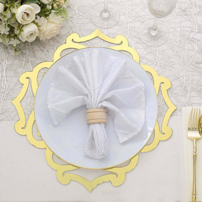 Elegant white napkin with wooden ring on decorative gold charger plate.