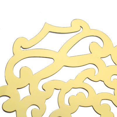 Gold decorative cutout design on a plain background