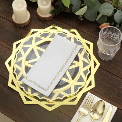 Gold geometric charger plate with clear glass, white napkin, and elegant table setting.
