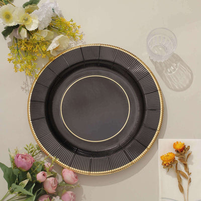 Elegant black plate with gold trim, surrounded by flowers.