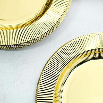 Gold decorative plates with textured rims on a white background.