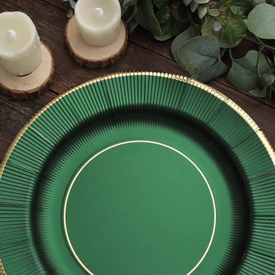 Green decorative plate with gold rim and textured design, styled with candles and greenery.