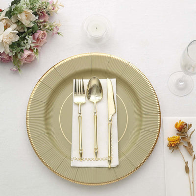 Elegant gold-accented cutlery on a decorative plate with a floral arrangement