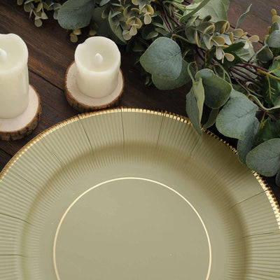 Elegant green decorative plate with gold trim, surrounded by candles and foliage.