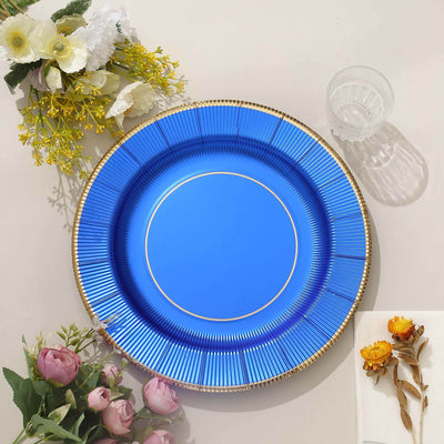 Blue decorative plate with gold trim and floral accents on a neutral background.