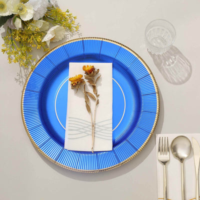 Blue decorative plate with napkin and dried flowers on a table setting.