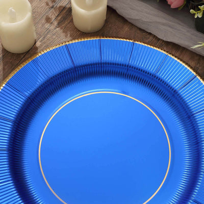 Blue decorative plate with gold rim on a wooden surface.
