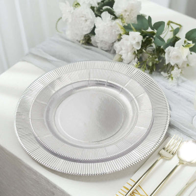 Elegant silver charger plate on a beautifully set dining table.