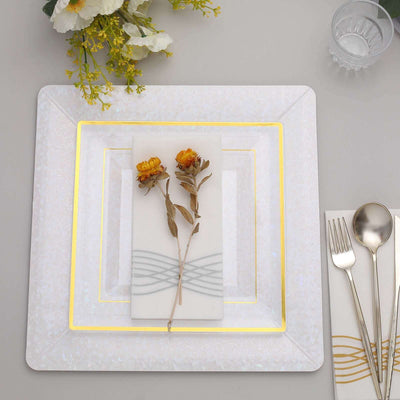 Elegant table setting with decorative plate and flowers, featuring gold accents.