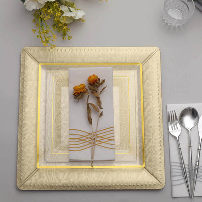 Elegant gold charger plate with white napkin and dried flowers on a stylish table setting.