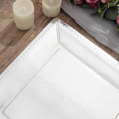 Textured rectangular serving tray on a wooden surface with decorative elements.