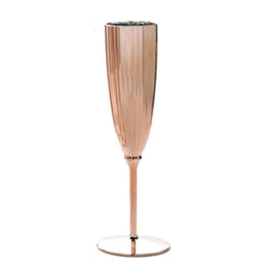 Rose gold champagne flute with a sleek, ribbed design.