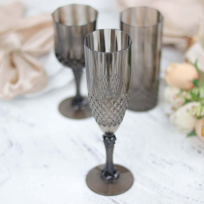 Elegant smoke-colored champagne flutes on a white background