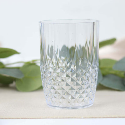 Clear geometric glass tumbler on a neutral surface.