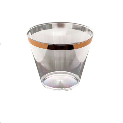 Clear glass cup with a gold band on a white background