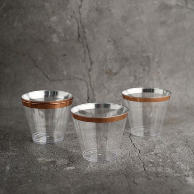 Clear plastic cups with copper bands, three-pack display.