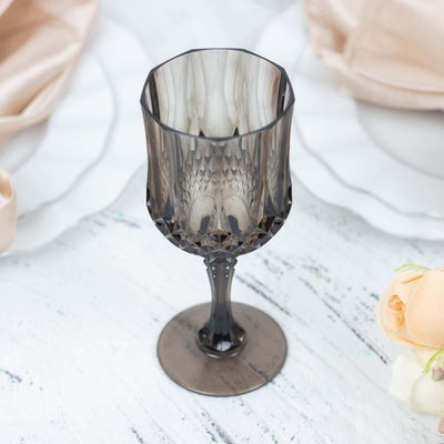 Elegant smoky glass goblet with intricate design and a tall stem.