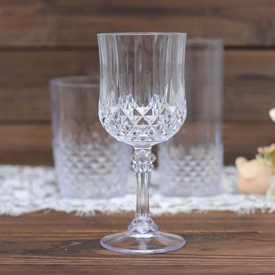 Crystal wine glass with intricate cut design and elegant stem.
