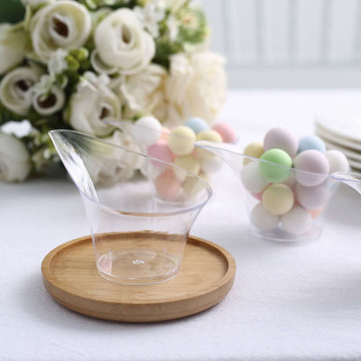 Clear dessert cups with pastel candies and a wooden serving tray.