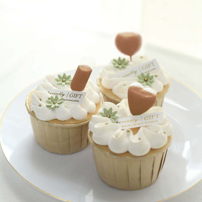 Decorative cupcakes with unique toppings on a white plate.