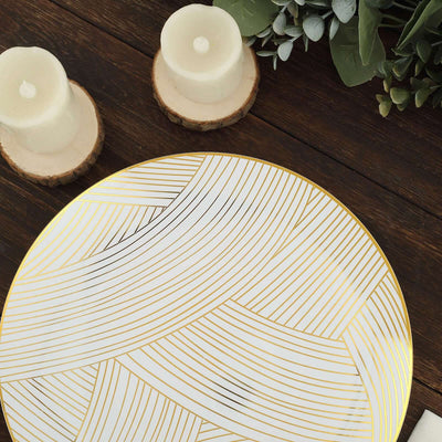 Decorative plate with gold line design, styled with candles and wooden accents.