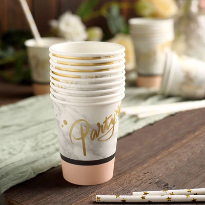 Party-themed paper cups in a stack with gold accents.