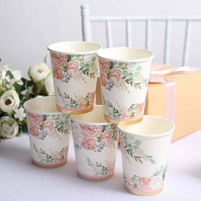 Floral printed disposable cups arranged with gift box in background.