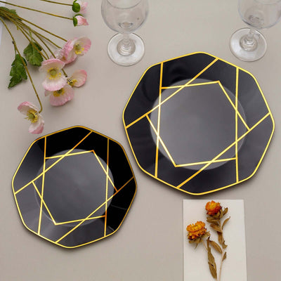 Elegant black plates with gold geometric design, styled with flowers and glasses.
