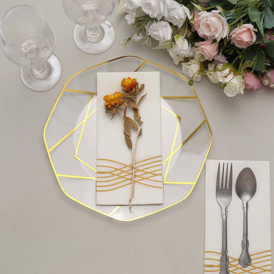 Elegant dining plate with floral decor and cutlery set on a table.