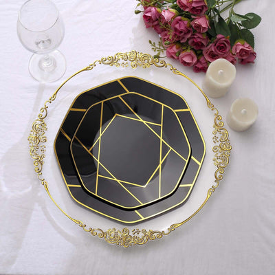 Elegant black and gold decorative plate on a white table with flowers and candles.
