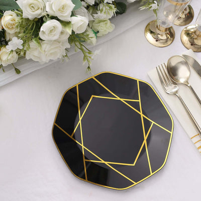 Black octagonal plate with gold geometric design on a table setting.