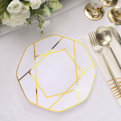 Elegant white plate with gold geometric design on a table setting.