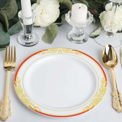 Elegant white plate with gold and red trim, set on a beautifully arranged table.