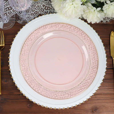 Elegant pink dinner plate with textured rim on a decorative charger.
