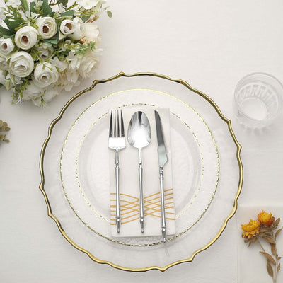 Elegant table setting with gold-accented plates and cutlery.