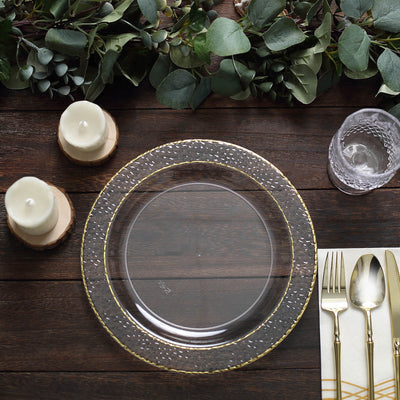 Clear decorative plate with gold rim, styled on a rustic wooden table.