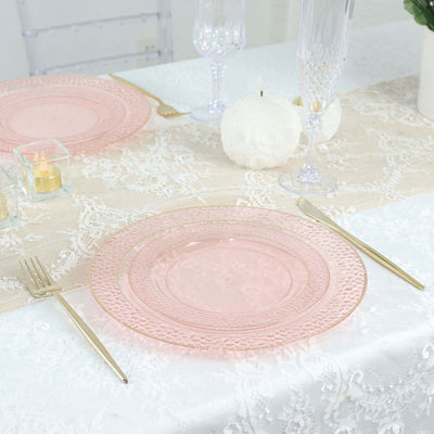 Elegant pink glass dinner plate on a lace table setting.