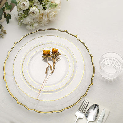 Elegant glass plate set with gold trim and dried flowers, styled on a table.