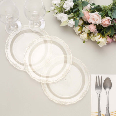 Elegant white plates with decorative edges, styled with glasses and flowers.