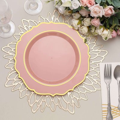 Pink decorative plate with gold trim on an elegant table setting.