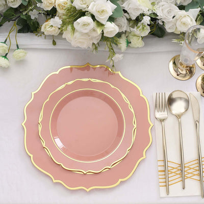 Elegant pink plates with gold trim set on a table with floral decor.