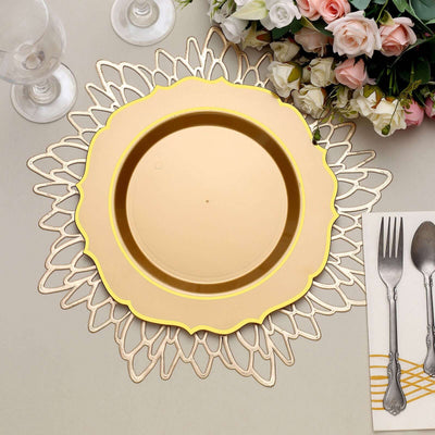Gold rimmed plate on decorative lace placemat with flowers and cutlery.