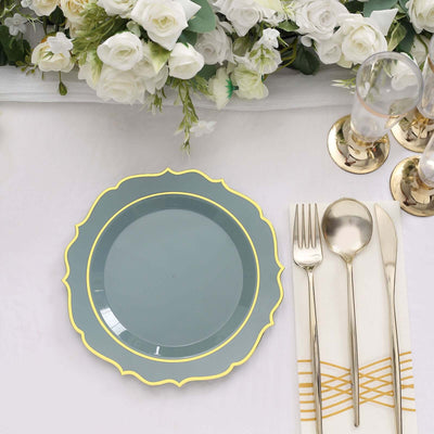 Elegant blue plate with gold trim on a beautifully arranged dining table.