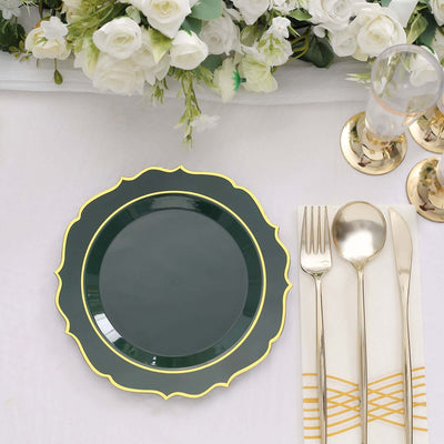 Green decorative plate with gold trim on a dining table setting.