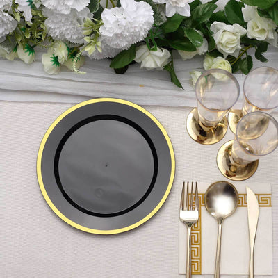 Elegant black plate with gold rim on a beautifully set dining table.