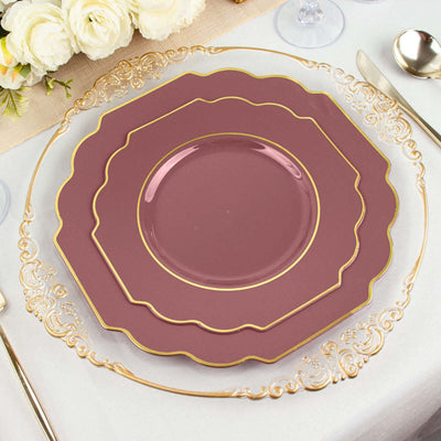 Elegant burgundy and gold-rimmed dinner plates stacked on a table setting.