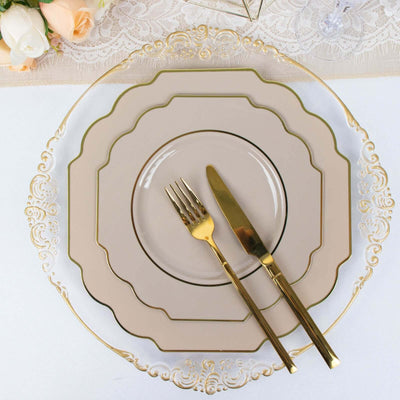 Elegant gold and beige dinnerware set with fork and knife on a decorated table.