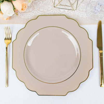 Elegant beige plate with gold trim on a table setting.